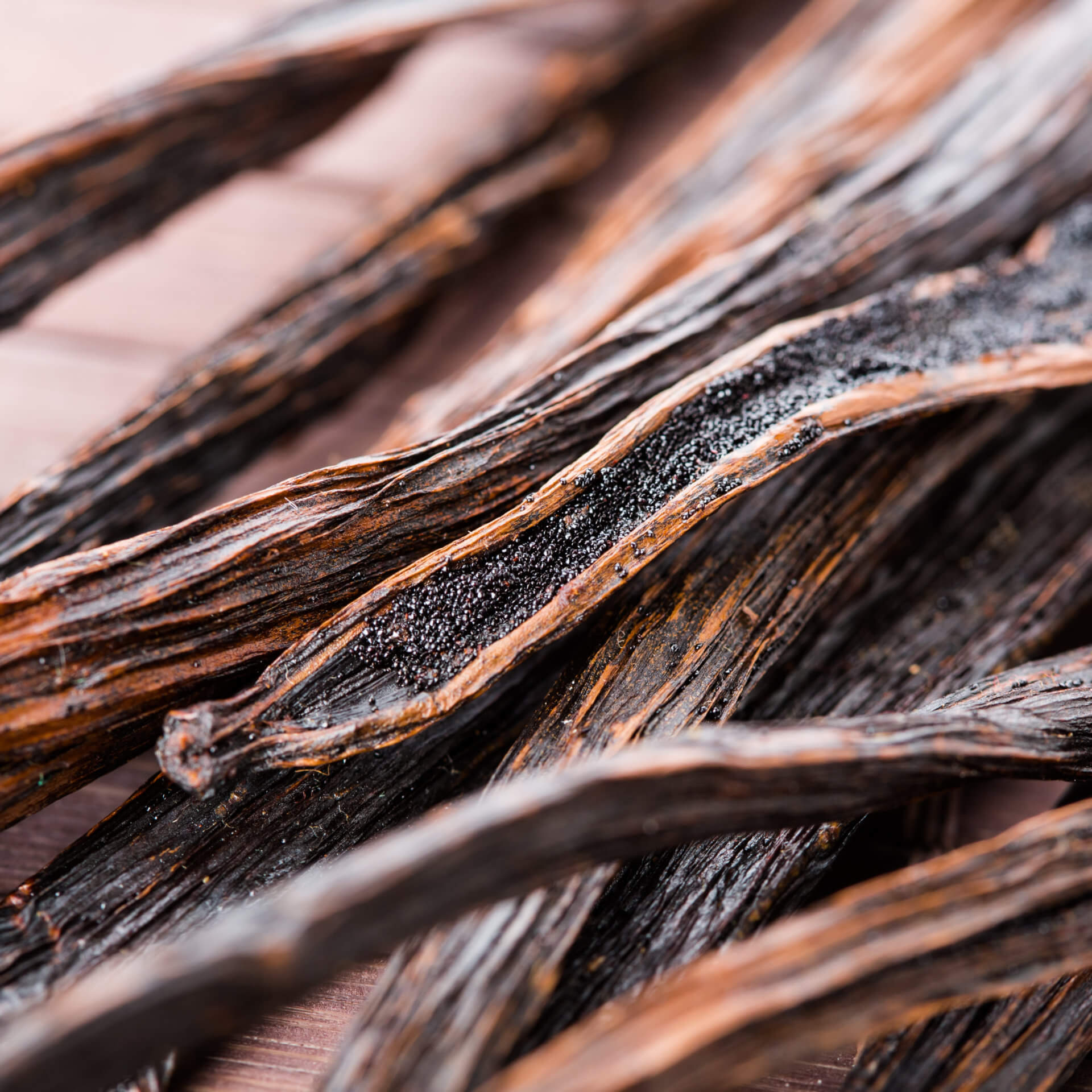 Vanilla,Pods,On,Wooden,Background.,Macro.